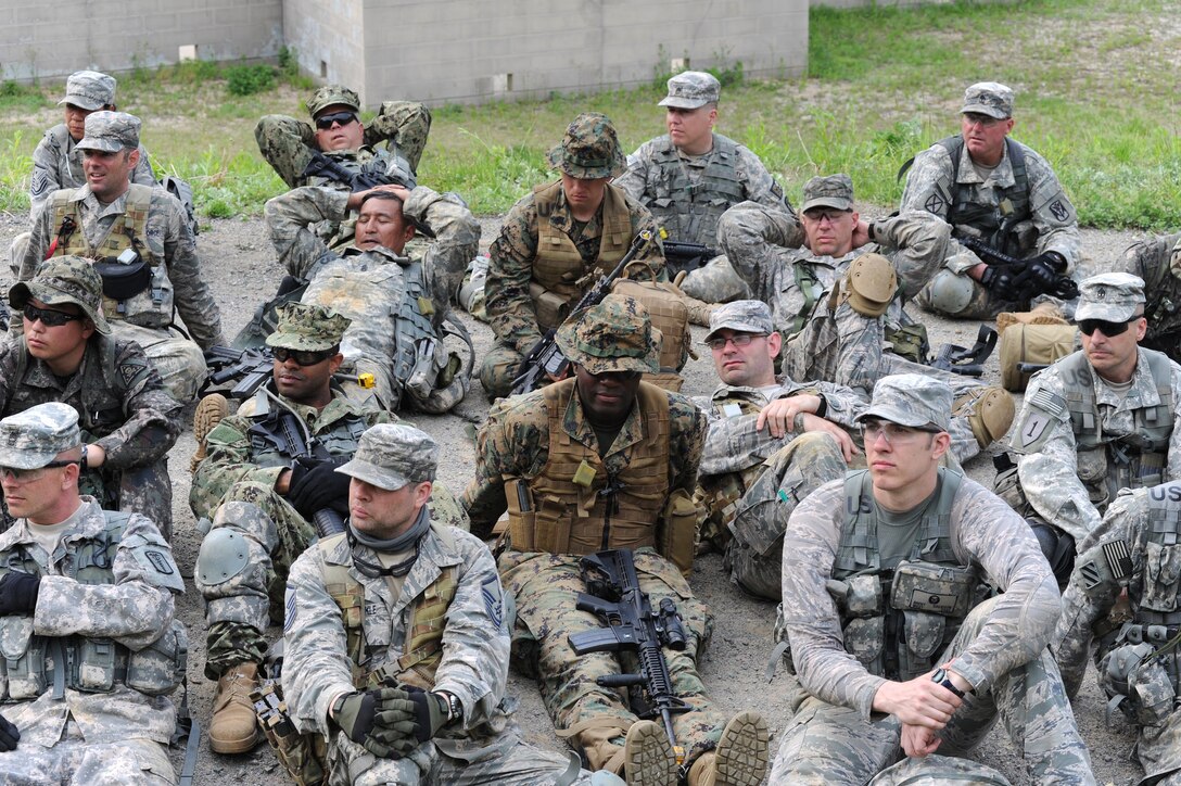 Members from each military branch sit and await further instruction at the "2015 Mangudai Warrior Challenge." The 58-hour event paired U.S. senior enlisted leaders with their Republic of Korea counterparts to accomplish different tasks through a range of scenarios while operating on limited food and sleep.  The United States Forces Korea event held May 13-15, 2015, is in its second year. (U.S. Army photo by Staff Sgt. Mark A. Kauffman)  