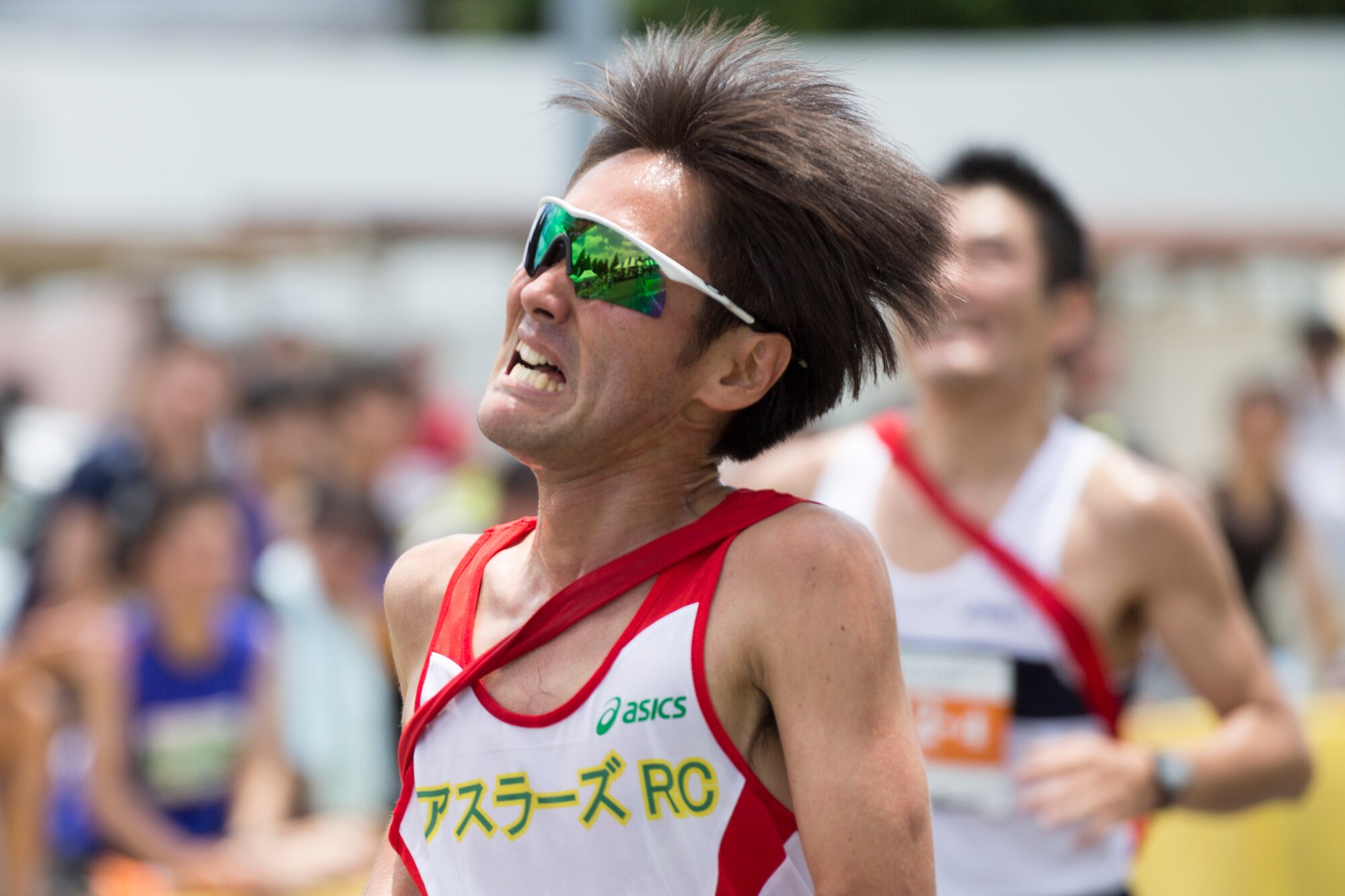 A runner crosses the finish line in 2nd place during the 31st Annual Ekiden Run at Yokota Air Base, Japan, June 7, 2015. More than 5,800 runners participated in the event sponsored by the Yokota Striders Running Club. (U.S. Air Force photo by Osakabe Yasuo/Released)