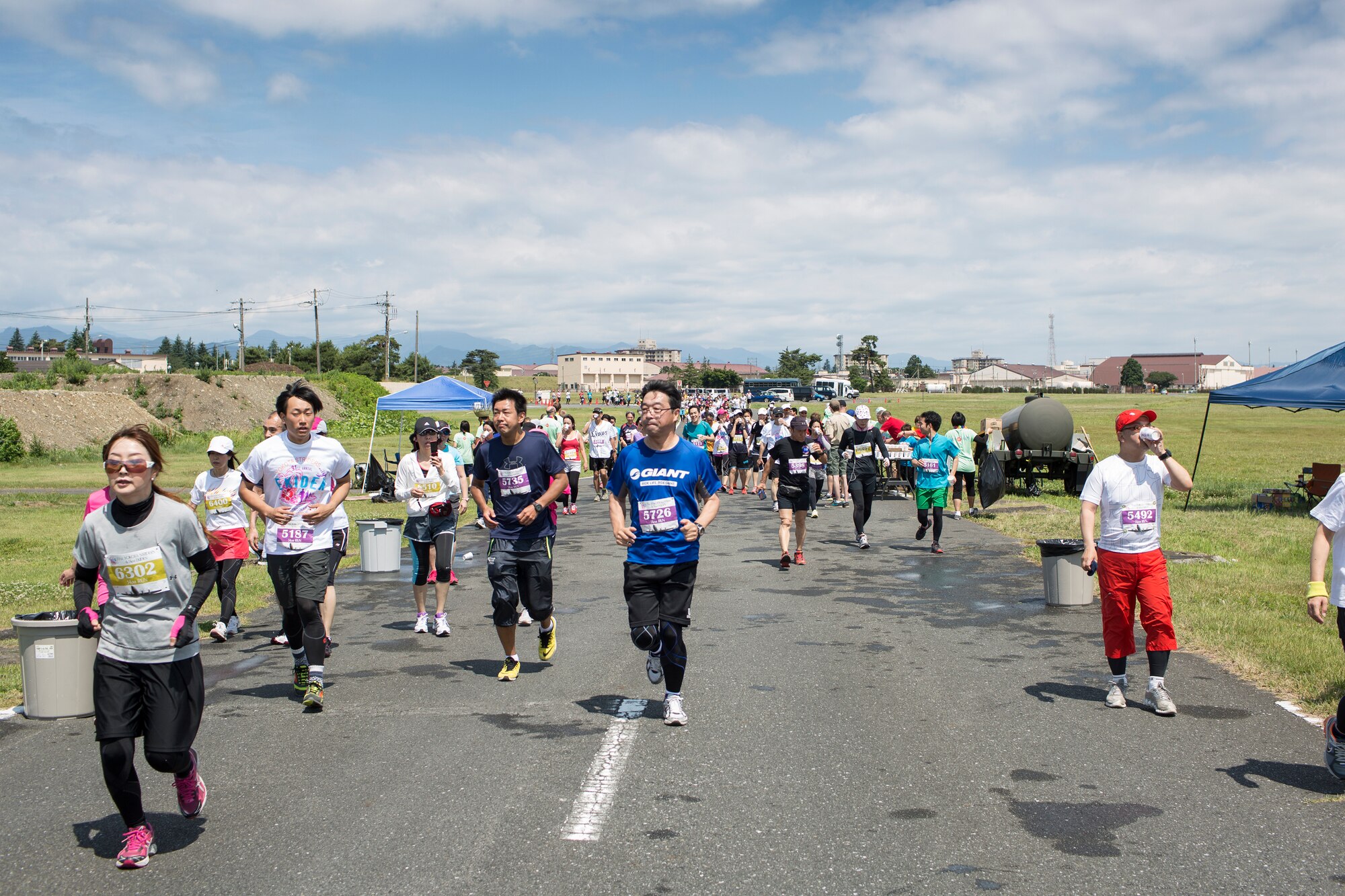 Runners participate in the 31st annual Ekiden 5k run at Yokota Air Base, Japan, June 7, 2015. The Yokota Striders running club sponsored the annual Ekiden Run consisting of three different races at this event: a 4-person 5k relay, 5k race, and 2k Kid’s Run. (U.S. Air Force photo by Osakabe Yasuo/Released)