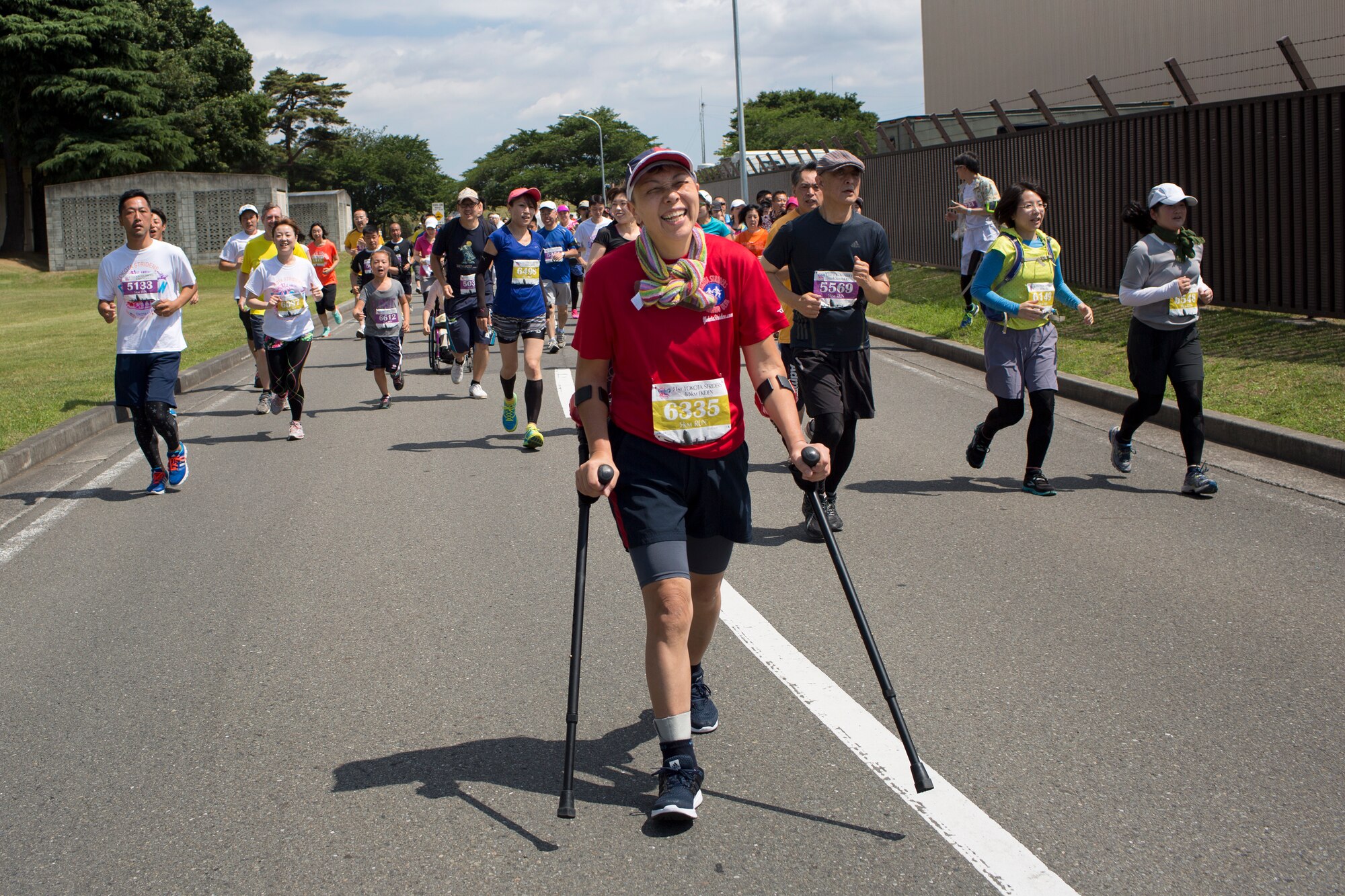 A disabled runner enjoys the 31st annual Ekiden 5K Run at Yokota Air Base, Japan, June 7, 2015. More than 5,800 runners and their families from on- and off-base participated in the event. (U.S. Air Force photo by Osakabe Yasuo/Released)