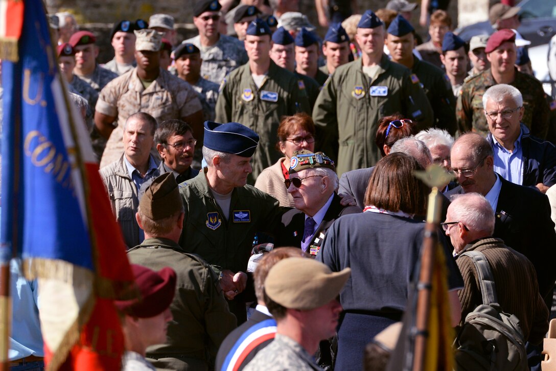 U.S. Air Force Lt. Gen. Darryl Roberson greets a World War II veteran during a World War II commemoration in Picauville, France, June 4, 2015. Roberson commands the 3rd Air Force.