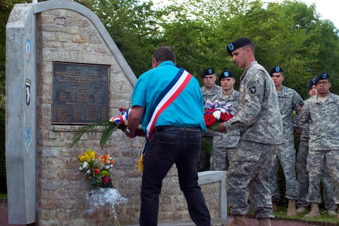 U.S. Army Staff Sgt. James Smith places a wreath to honor 1st Lt. Thomas Meehan III during a ceremony at the Currahee Memorial in Normandy, France, June 3, 2015. Smith is assigned to the 101st Airborne Division's 1st Battalion, 506th Infantry Regiment.
