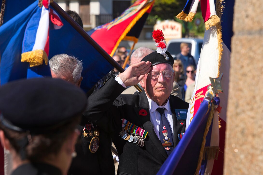 World War II veteran Edward Bullock, a former British airman, salutes during a WWII ceremony to commemorate D-Day at Sainte Laurent sur Mer, France, June 5, 2015, after laying a wreath for the allies who died while helping liberate France from Nazi occupation. Soldiers from the 29th Infantry and 1st Infantry divisions, the 173rd Airborne Brigade and the 3rd Ranger Battalion also participated in the event. More than 380 U.S. service members from Europe and affiliated D-Day historical units participated in the 71st anniversary of D-Day as part of Joint Task Force D-Day 71. Based in Sainte Mere Eglise, France, the task force is supporting events across Normandy from June 2-8, 2015, to commemorate the sacrifices of service members during the invasion.