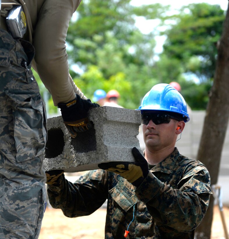 U.S. Marine Corps 1st Lt. Robert Brown helps move bricks at the Gabriela Mistral primary school in Ocotes Alto, Honduras, June 5, 2015. Brown is a combat engineering officer and construction site officer in charge assigned to the 271st Marine Wing Support Squadron, 2nd Marine Air Wing.