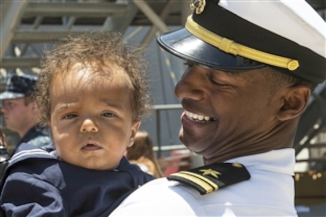 A sailor meets his newborn son for the first time in San Diego, June 4, 2015, after returning from a nearly 10-month deployment to the U.S. 5th and 7th Fleet areas of operations. The sailor is assigned to the guided-missile destroyer USS Sterett.
