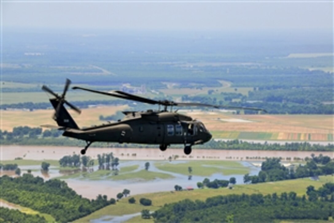 Louisiana Gov. Bobby Jindal and state cabinet members fly in a UH-60 Black Hawk helicopter to assess flooding from the Red River near Baton Rouge, La., June 5, 2015.