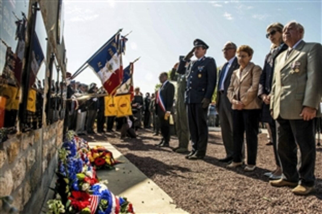Allied leaders salute the 9th Air Force Memorial, which commemorates fallen U.S. service members, in Picauville, France, June 4, 2015, during a D-Day ceremony.