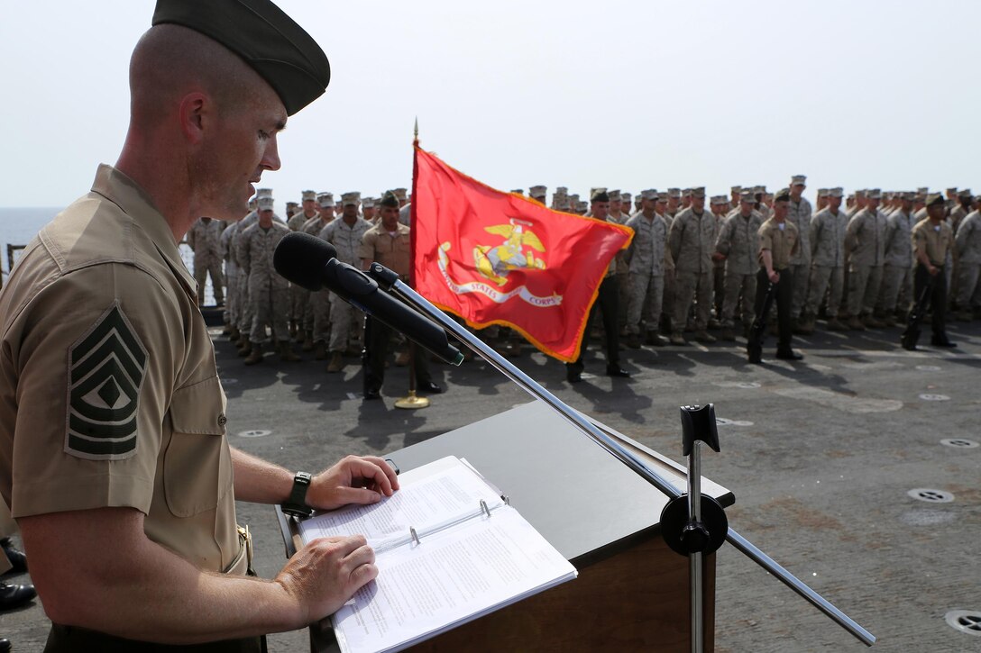 First Sgt. John Beckett, the company first sergeant for Kilo Company, Battalion Landing Team 3rd Battalion, 6th Marine Regiment, 24th Marine Expeditionary Unit, gives a speech during the Battle of Midway ceremony aboard the dock landing ship USS Fort McHenry (LSD 43), June 6, 2015. The 24th MEU is embarked on the ships of the Iwo Jima Amphibious Ready Group and deployed to maintain regional security in the U.S. 5th Fleet area of operations. (U.S. Marine Corps photo by Sgt. Devin Nichols)