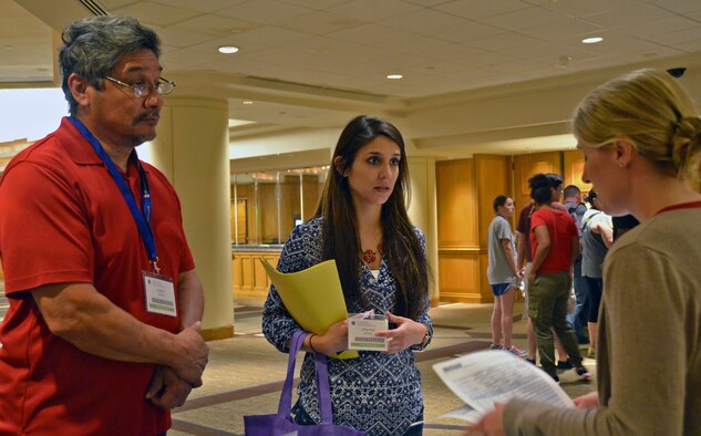 Maj. Laura Haver of the Air Force Reserve Yellow Ribbon Reintegration Program talks with Staff Sgt. Cristina Moreno and her father, retired Soldier Albert Moreno, during registration at a training weekend May 29, 2015, in Washington, D.C. The sergeant is a vehicle maintenance specialist with the 507th Logistics Readiness Squadron, Tinker Air Force Base, Okla., and recently returned from
an overseas deployment. (U.S. Air Force photo by Senior Airman Monica Ricci)