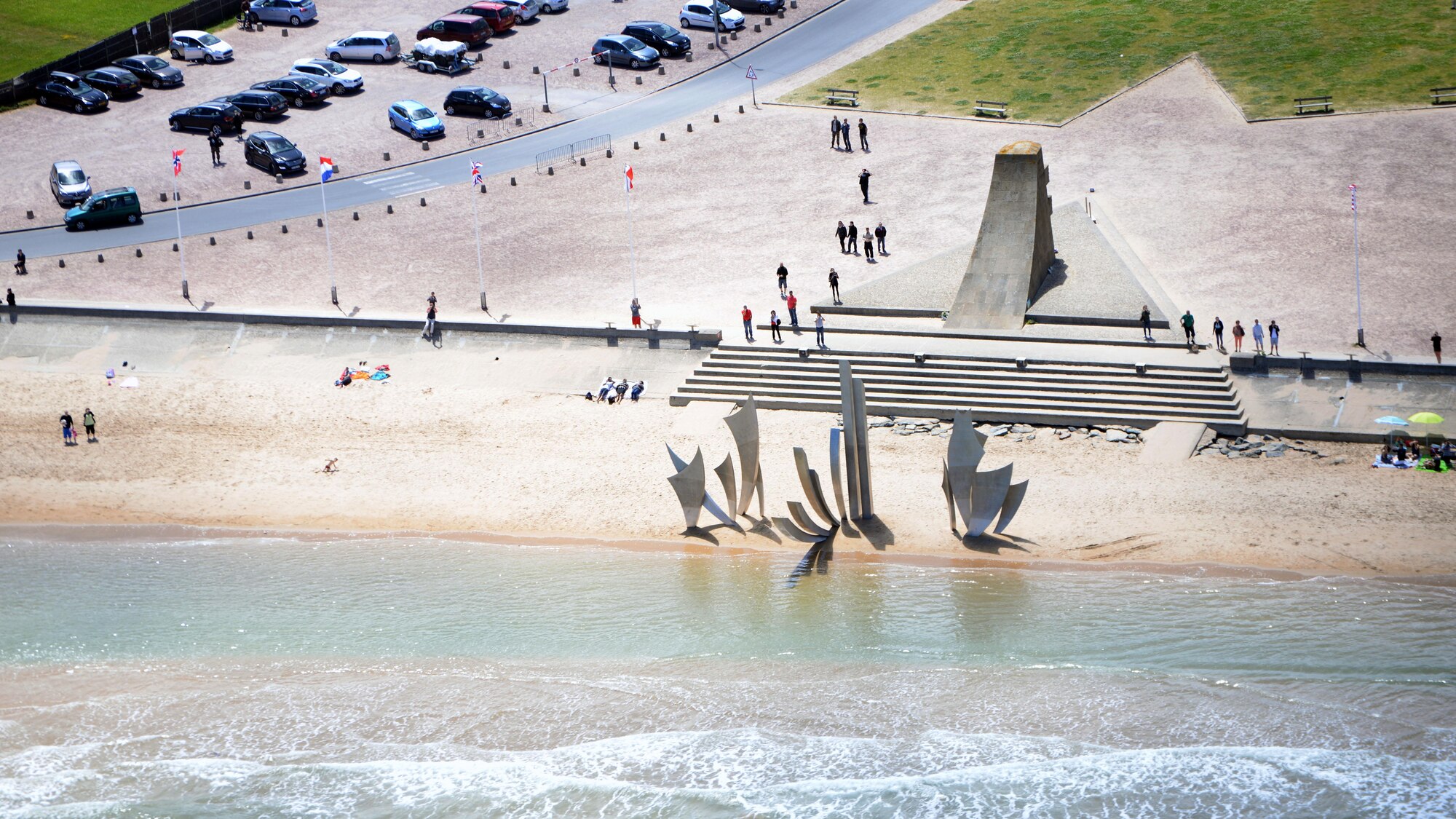 An aerial perspective of the memorial at Omaha Beach in Normandy, France, June 7, 2015, after the MC-130J Commando II aircrew from the 67th Special Operations Squadron dropped more than 60 U.S. Special Operations Command – Europe operators over the historic La Fiere drop zone outside of Sainte Mere Eglise, to commemorate the 71st anniversary of the D-Day landings. (U.S. Air Force photo by Tech. Sgt. Stacia Zachary)
