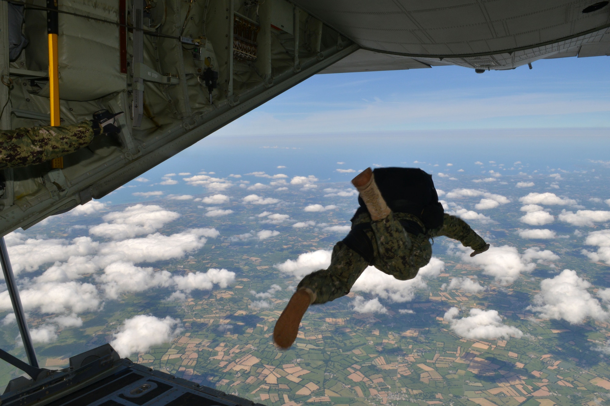 U.S. Special Operations Command -- Europe operator jumps off the ramp of an MC-130J Commando II assigned to the 67th Special Operations Squadron at RAF Mildenhall, England, to perform military free fall to the historic La Fiere drop zone near Sainte Mere Eglise, Normandy, France, June 7, 2015, to commemorate the 71st anniversary of D-Day. More than 60 SOCEUR operators performed the MFF jumps which were a small portion of the commemorative events which took place in strategic World War II sites throughout Normandy. (U.S. Air Force photo by Tech. Sgt. Stacia Zachary)