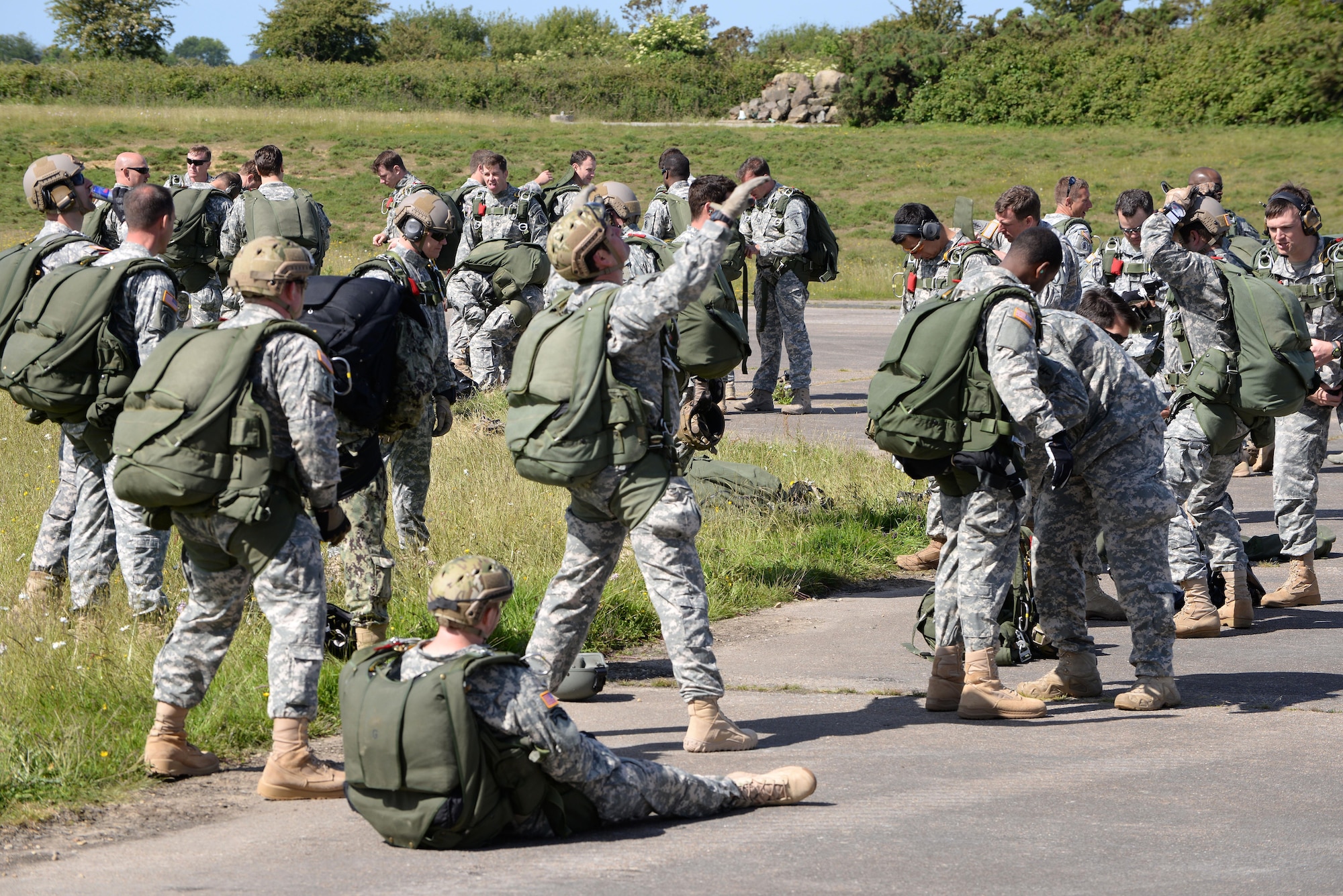 U.S. Special Operations Command -- Europe operators don their parachutes and other gear before loading an MC-130J Commando II assigned to the 67th Special Operations Squadron at RAF Mildenhall, England, to perform military free fall to their objective, the historic La Fiere drop zone near Sainte Mere Eglise, Normandy, France, June 7, 2015, to commemorate the 71st anniversary of D-Day. More than 60 SOCEUR operators performed the MFF jumps which were a small portion of the commemorative events which took place in strategic World War II sites throughout Normandy. (U.S. Air Force photo by Tech. Sgt. Stacia Zachary)