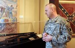Army Lt. Col. Mark Whitlock, director of the Illinois State Military Museum, reviews the Civil War display at the museum in Springfield, Ill. The museum features the military history of Illinois.