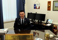 Airman 1st Class Duncan McElroy, 81st Training Wing Public Affairs photojournalist, sits behind Chief Master Sgt. of the Air Force James Cody’s desk during a Capitol Hill visit, May 14, 2015, at the Pentagon. McElroy was selected to accompany base leadership on the trip, which was meant to foster partnerships between Air Force and state congressional representatives. (Courtesy photo)