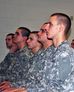 Army Pvt. Corey Blackwood (far right) listens to GED Plus Commandant Army Lt. Col. Mary Maguire as she congratulates the current class of 65 recruits for earning their GED Diplomas, Feb. 18, 2011, at Camp Robinson in North Little Rock, Ark. Blackwood, a Michigan Army National Guard Citizen-Soldier, was the 10,000th recruit to graduate from the program.