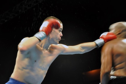 Brian Macy, a sergeant with the 250th Engineer Company, Connecticut Army National Guard, lands a glove on JC Peterson during his comeback to professional boxing at the Mohegan Sun Arena, Conn. in Feb. 4, 2011.