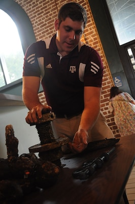 Parker Brooks, a conservator and graduate student from Texas A&M University’s Conservation Research Laboratory, demonstrates the function of an elevator screw prior to a free lecture on the CSS Georgia at the Savannah History Museum, June 2.