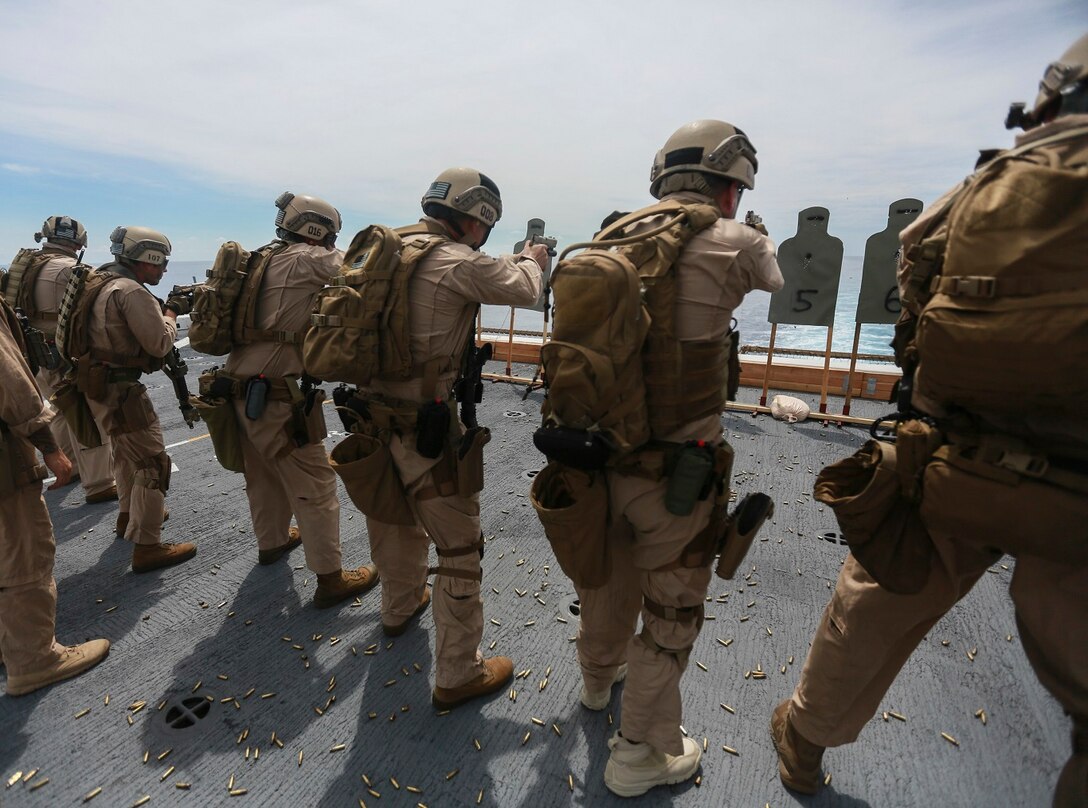 U.S. Marines with the 15th Marine Expeditionary Unit’s Maritime Raid Force fire their weapons on the flight deck of the USS Anchorage (LPD 23) in the South China Sea, June 7, 2015. The 15th MEU’s MRF must maintain their marksmanship proficiency while at sea on deployment. (U.S. Marine Corps photo by Sgt. Steve H. Lopez/Released)