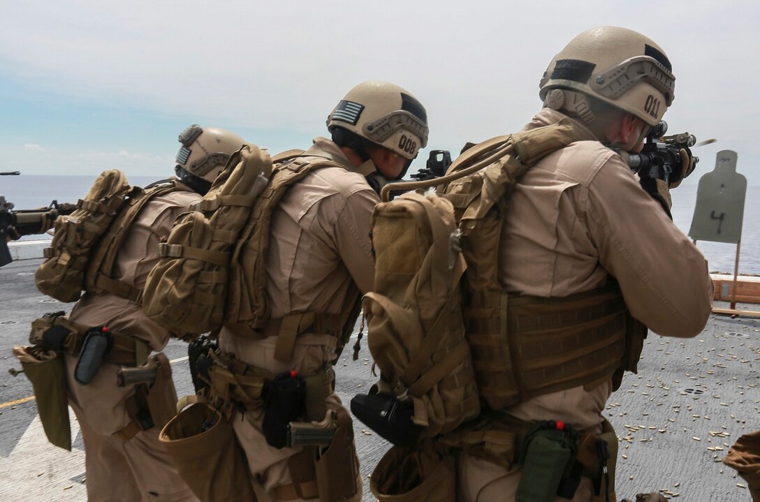 U.S. Marines with the 15th Marine Expeditionary Unit’s Maritime Raid Force fire their weapons on the flight deck of the USS Anchorage (LPD 23) in the South China Sea, June 7, 2015. The 15th MEU’s MRF must maintain their marksmanship proficiency while at sea on deployment. (U.S. Marine Corps photo by Sgt. Steve H. Lopez/Released)
