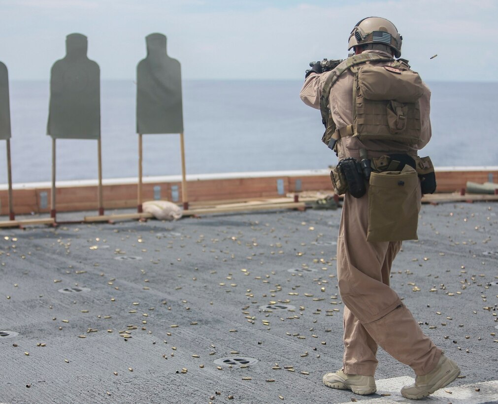 A U.S. Marine with the 15th Marine Expeditionary Unit’s Maritime Raid Force fires his weapon at his target on the flight deck of the USS Anchorage (LPD 23) in the South China Sea, June 7, 2015. The 15th MEU’s MRF must maintain their marksmanship proficiency while at sea on deployment. (U.S. Marine Corps photo by Sgt. Steve H. Lopez/Released)