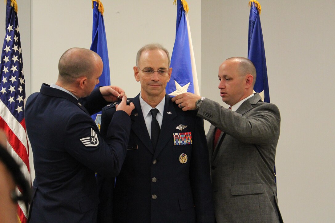 Staff Sgt. Ross Ediger and Zachery Ediger pin the third star on their father Lt. Gen. Mark Ediger during a promotion ceremony June 8, 2015, at the Defense Health Headquarters in Falls Church, Va. Ediger became the 22nd Air Force surgeon general during the ceremony, officiated by Air Force Vice Chief of Staff Gen. Larry O. Spencer. (U.S. Air Force photo/Jonathan Stock) 