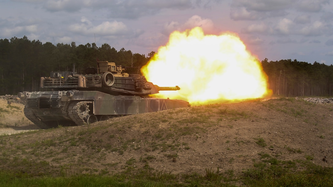 A crew operating the M1A1 Abrams tank fires at a target during the 13th annual TIGERCOMP aboard Camp Lejeune, N.C., June 5, 2015. The best tank gunner crews from 1st Tank Battalion, 2nd Tank Battalion and 4th Tank Battalion competed for top honors and the McCard trophy bringing the entire tank community, including tank battalion veterans, together for an entertaining display of the tanks force and powerful capabilities. (U.S. Marine Corps photo by Cpl. Michelle Reif/Released)