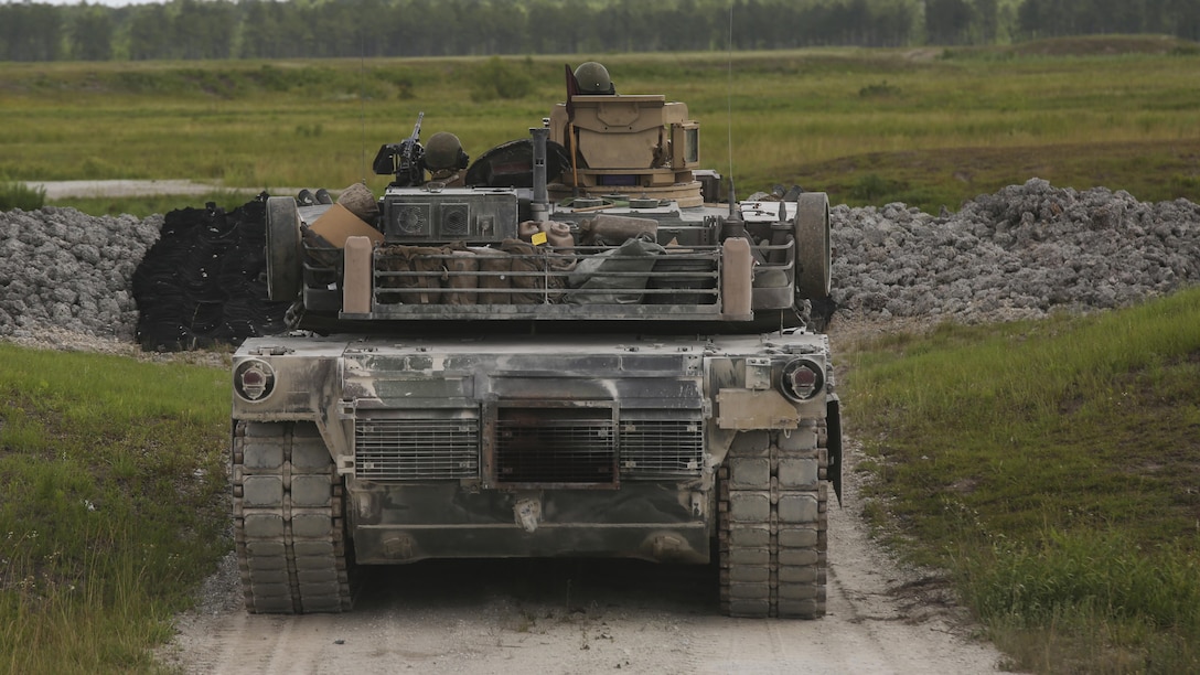 A crew operating the M1A1 Abrams tank prepares to fire at a target during the 13th annual TIGERCOMP aboard Camp Lejeune, N.C., June 5, 2015. The best tank gunner crews from 1st Tank Battalion, 2nd Tank Battalion and 4th Tank Battalion competed for top honors and the McCard trophy bringing the entire tank community, including tank battalion veterans, together for an entertaining display of the tanks force and powerful capabilities. (U.S. Marine Corps photo by Cpl. Michelle Reif/Released