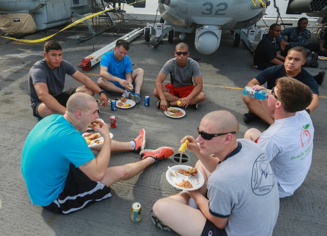 The Marines and Sailors of the 15th Marine Expeditionary Unit and USS Anchorage (LPD 23) enjoy their food at a steel beach picnic aboard the USS Anchorage in the Philippine Sea, June 4, 2015. The Marines and Sailors of the 15th MEU and Essex Amphibious Ready Group hold such events to boost morale and build camaraderie. (U.S. Marine Corps photo by Sgt. Steve H. Lopez/Released)
