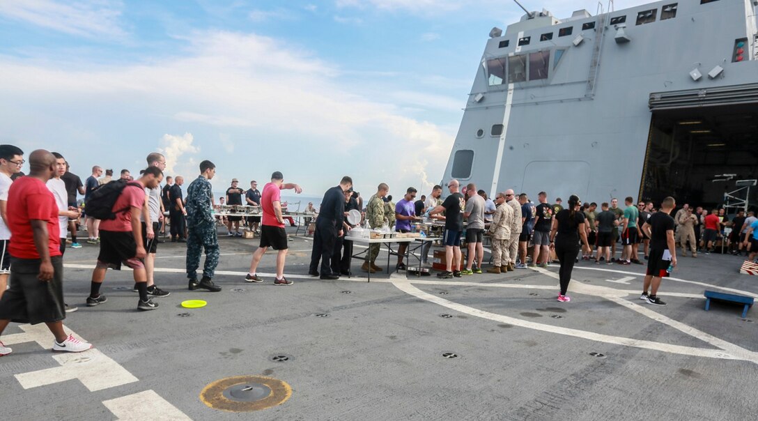 The Marines and Sailors of the 15th Marine Expeditionary Unit and USS Anchorage (LPD 23) fill their plates with food at a steel beach picnic aboard the USS Anchorage in the Philippine Sea, June 4, 2015. The Marines and Sailors of the 15th MEU and Essex Amphibious Ready Group hold such events to boost morale and build camaraderie. (U.S. Marine Corps photo by Sgt. Steve H. Lopez/Released)