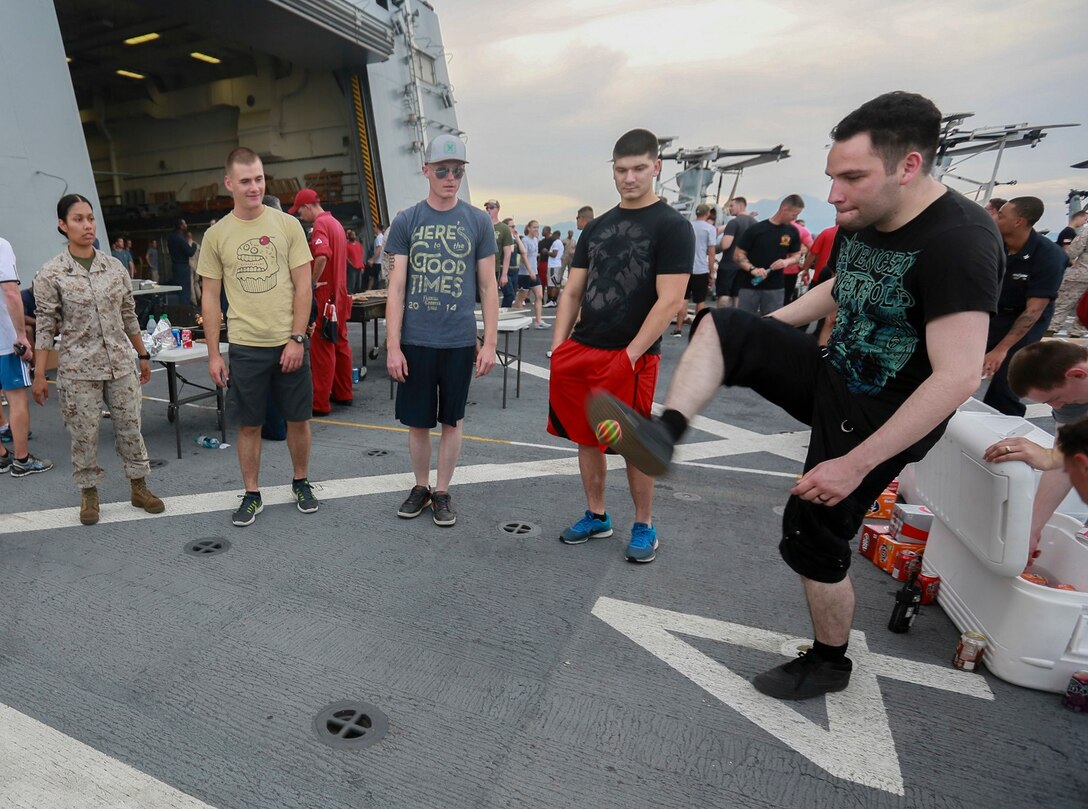 The Marines and Sailors of the 15th Marine Expeditionary Unit and USS Anchorage (LPD 23) enjoy the afternoon at a steel beach picnic aboard the USS Anchorage in the Philippine Sea, June 4, 2015. The Marines and Sailors of the 15th MEU and Essex Amphibious Ready Group hold such events to boost morale and build camaraderie. (U.S. Marine Corps photo by Sgt. Steve H. Lopez/Released)