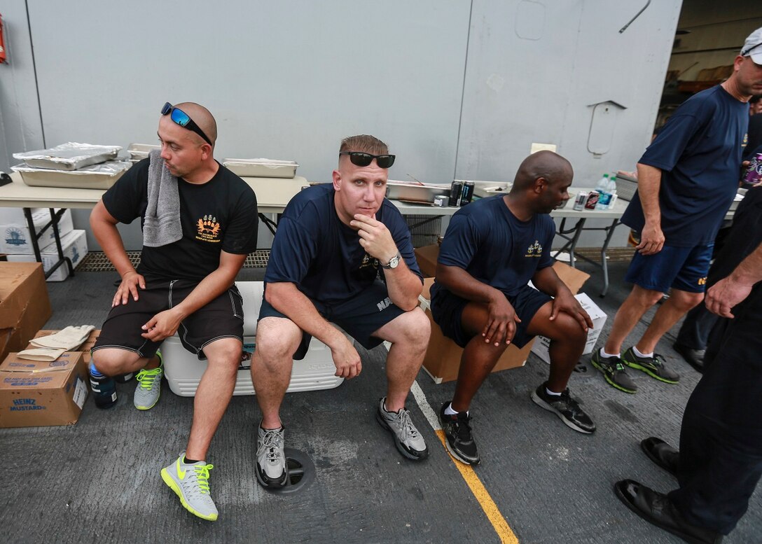 The Marines and Sailors of the 15th Marine Expeditionary Unit and USS Anchorage (LPD 23) enjoy the afternoon at a steel beach picnic aboard the USS Anchorage in the Philippine Sea, June 4, 2015. The Marines and Sailors of the 15th MEU and Essex Amphibious Ready Group hold such events to boost morale and build camaraderie. (U.S. Marine Corps photo by Sgt. Steve H. Lopez/Released)