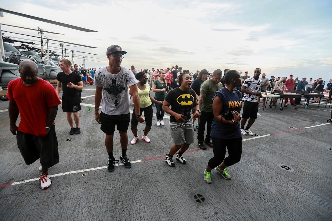 The Marines and Sailors of the 15th Marine Expeditionary Unit USS Anchorage (LPD 23) enjoy the afternoon at a steel beach picnic aboard the USS Anchorage in the Philippine Sea, June 4, 2015. The Marines and Sailors of the 15th MEU and Essex Amphibious Ready Group hold such events to boost morale and build camaraderie. (U.S. Marine Corps photo by Sgt. Steve H. Lopez/Released)