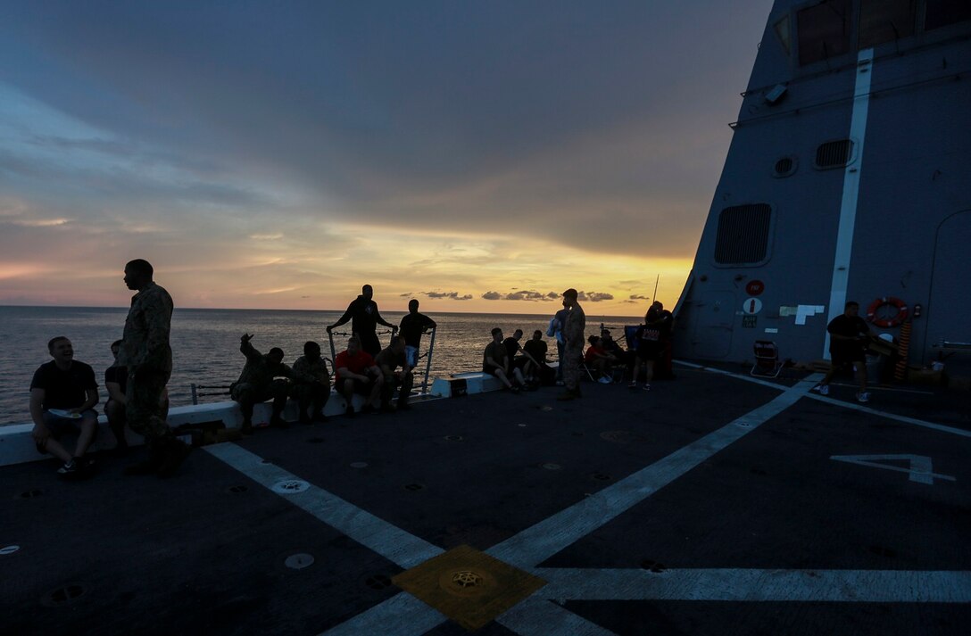 The Marines and Sailors of the 15th Marine Expeditionary Unit and USS Anchorage (LPD 23) enjoy the afternoon at a steel beach picnic aboard the USS Anchorage in the Philippine Sea, June 4, 2015. The Marines and Sailors of the 15th MEU and Essex Amphibious Ready Group hold such events to boost morale and build camaraderie. (U.S. Marine Corps photo by Sgt. Steve H. Lopez/Released)