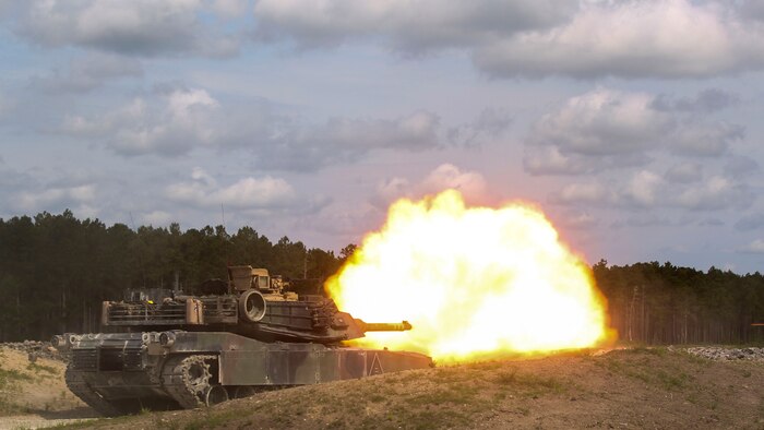 A crew operating the M1A1 Abrams tank fires at a target during the 13th annual TIGERCOMP at Marine Corps Base Camp Lejeune, N.C., June 5, 2015. The best tank gunner crews from 1st Tank Battalion, 2nd Tank Battalion and 4th Tank Battalion competed for top honors and the McCard trophy bringing the entire tank community, including tank battalion veterans, together for an entertaining display of the tanks force and powerful capabilities.