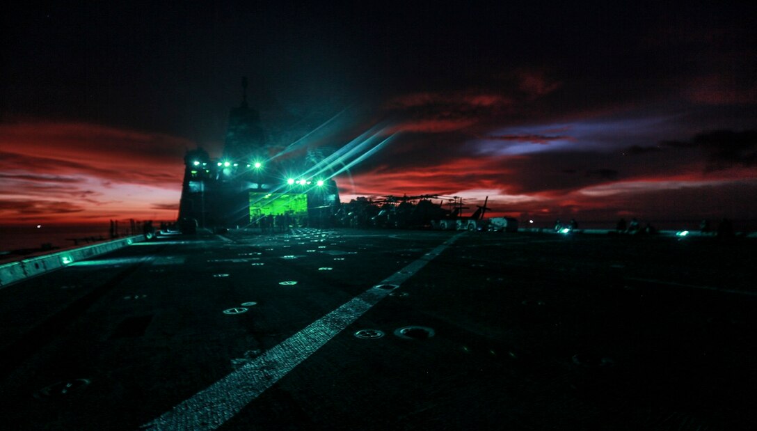 The Marines and Sailors of the 15th Marine Expeditionary Unit and USS Anchorage (LPD 23) enjoy the evening at a steel beach picnic aboard the USS Anchorage in the Philippine Sea, June 4, 2015. The Marines and Sailors of the 15th MEU and Essex Amphibious Ready Group hold such events to boost morale and build camaraderie. (U.S. Marine Corps photo by Sgt. Steve H. Lopez/Released)