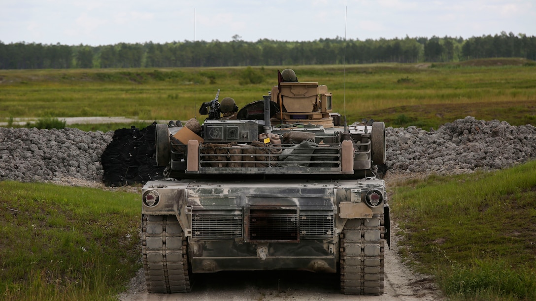 A crew operating the M1A1 Abrams tank prepares to fire at a target during the 13th annual TIGERCOMP at Marine Corps Base Camp Lejeune, N.C., June 5, 2015. The best tank gunner crews from 1st Tank Battalion, 2nd Tank Battalion and 4th Tank Battalion competed for top honors and the McCard trophy bringing the entire tank community, including tank battalion veterans, together for an entertaining display of the tanks force and powerful capabilities.
