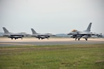 KUNSAN AIR BASE, Republic of Korea (June 4, 2015) - A Republic of Korea Air Force KF-16 Fighting Falcon from the 123rd Fighter Squadron, Seosan Air Base, taxis on the flightline as two U.S. Air Force 35th Fighter Squadron F-16 Fighting Falcons prepare to taxi for a sortie at Kunsan Air Base during Exercise Buddy Wing 15-4. In an effort to enhance U.S. and ROKAF combat capability, Buddy Wing exercises are conducted multiple times throughout the year on the peninsula to sharpen interoperability between the allied forces so that if need be, they are always ready to fight as a combined force. 