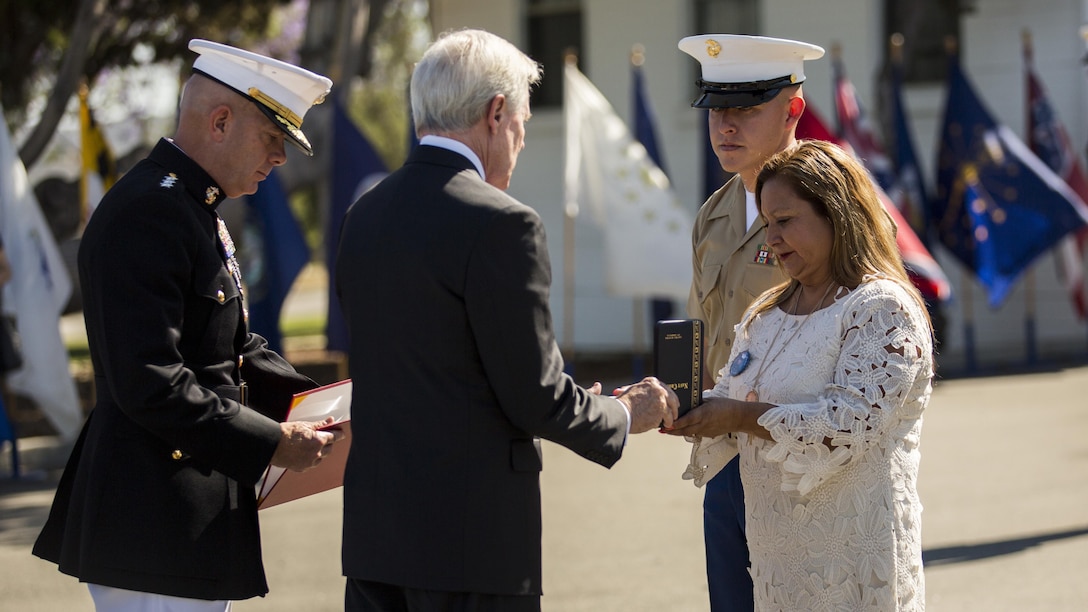 Secretary of the Navy Ray Mabus presents the Navy Cross to Rosa Peralta, the mother of the late Sgt. Rafael Peralta, aboard Camp Pendleton, Calif., June 8, 2015. Sgt. Rafael Peralta was awarded the Navy Cross posthumously after sacrificing his life by absorbing the blast of an enemy grenade and shielding fellow Marines only feet away while serving with Regimental Combat Team 7, 1st Marine Division in Fallujah, Al Anbar province, Iraq, on Nov. 15, 2004. (U.S. Marine Corps photo by Sgt. Luis Vega/Released)