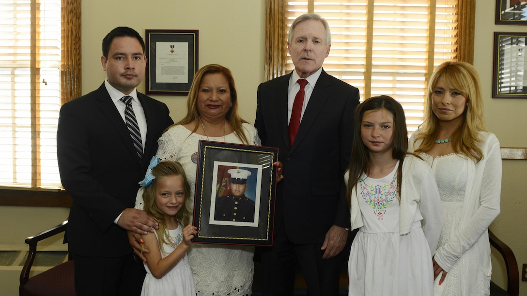 150608-N-AC887-002 CAMP PENDLETON (June 8, 2015) Secretary of the Navy (SECNAV) Ray Mabus poses for a group photo with the family members of Marine Sgt. Rafael Peralta before presenting them with a Navy Cross, the Navy and Marine Corps' second highest medal for valor at Camp Pendleton. Mabus  posthumously awarded the medal for actions Peralta took in 2004. (U.S. Navy photo by Chief Mass Communication Specialist Sam Shavers/Released)