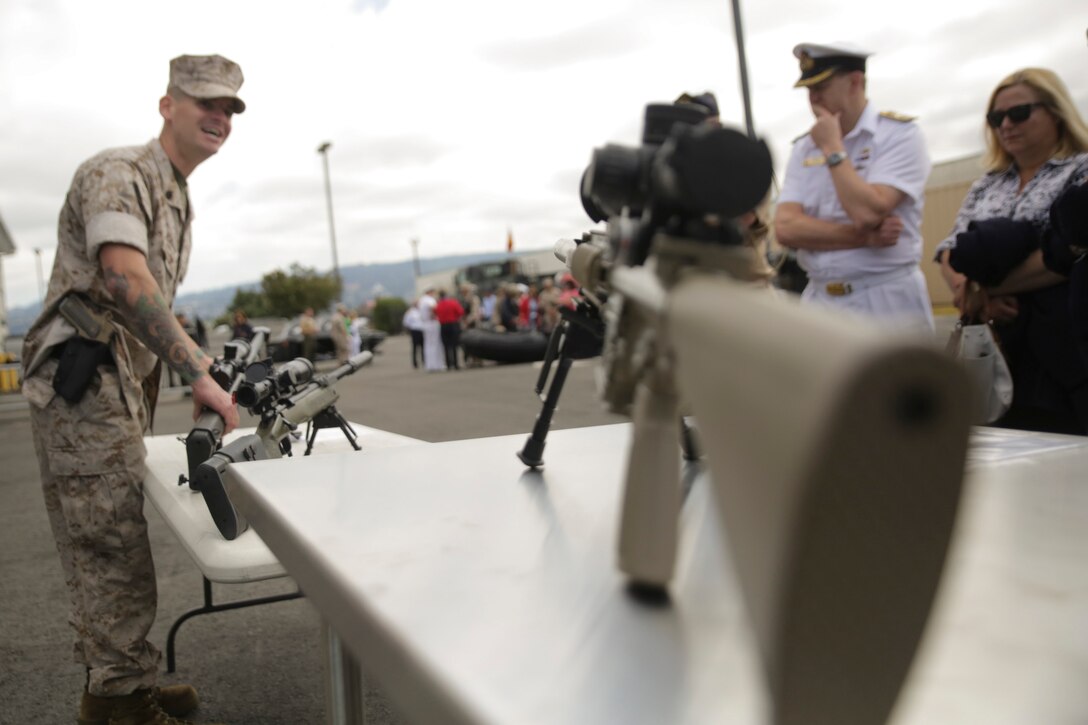 Staff Sgt. Thomas R. Monahan, Company Armorer, 4th Force Reconnaissance Company, 4th Marine Division, Marine Forces Reserve, explains the characteristics of the rifles on display to Navy and flag officers in Alameda, California June 2, 2015. Marines welcomed foreign military attachés and their spouses, as well as members of the defense foreign liaison office, to a static display of vehicles, weapons and gear used by force reconnaissance Marines, during the attachés' regional tour. (U.S. Marine photo by Cpl. Ian Ferro)