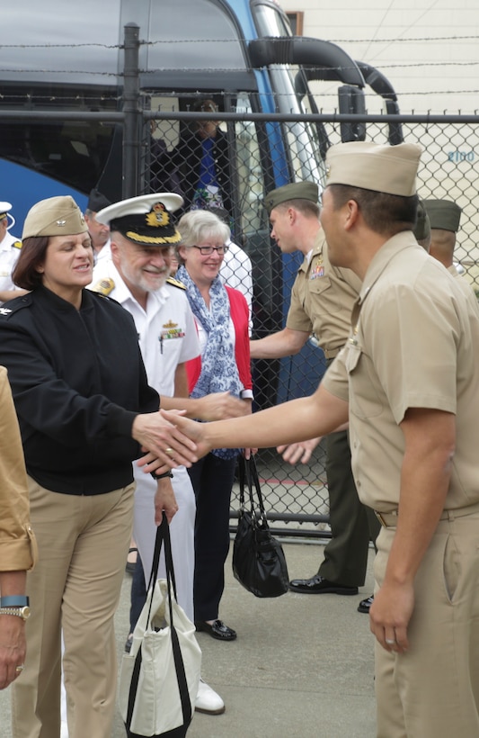 Marines with 4th Force Reconnaissance Company, 4th Marine Division, Marine Forces Reserve, welcome and shake hands with Navy and flag officers in Alameda, California, June 2, 2015. Marines welcomed foreign military attachés and their spouses, as well as members of the defense foreign liaison office, to a static display of vehicles, weapons and gear used by force reconnaissance Marines, during the attachés' regional tour.