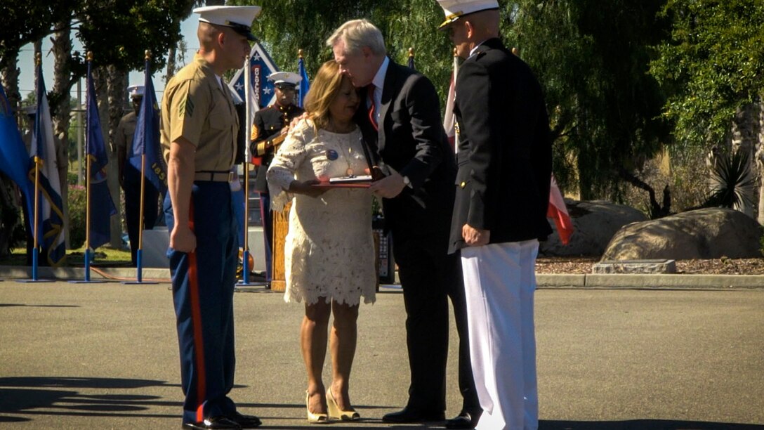 Secretary of the Navy Ray Mabus presents the Navy Cross to Rosa Peralta, the mother of the late Sgt. Rafael Peralta, at Marine Corps Base Camp Pendleton, California, June 8, 2015. Sgt. Rafael Peralta was awarded the Navy Cross posthumously after sacrificing his life by absorbing the blast of an enemy grenade and shielding fellow Marines only feet away while serving with Regimental Combat Team 7, 1st Marine Division in Fallujah, Al Anbar province, Iraq, on Nov. 15, 2004.