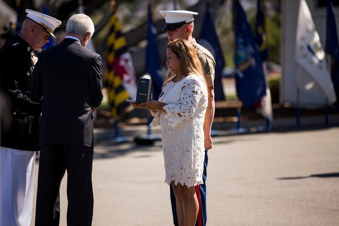 Secretary of the Navy Ray Mabus presents the Navy Cross to Rosa Peralta, the mother of the late Sgt. Rafael Peralta, during a ceremony held in his honor aboard Camp Pendleton, Calif., June 8, 2015. Peralta was awarded the Navy Cross for his actions in support of Operation Al Fajr in Fallujah, Al Anbar province, Iraq on Nov. 15, 2004, where he covered an enemy grenade with his body protect his fellow Marines. (U.S. Marine Corps photo by Lance Cpl. Clarence A. Leake/Released)