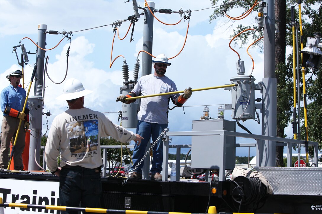 Electricians perform a live-wire safety demonstration during the Emergency Preparedness Fair in the station theater at Marine Corps Air Station Cherry Point, N.C., June 4, 2015. During the fair, service members and their families learned about resources available at Cherry Point and in surrounding communities to prepare for and respond to hurricanes and other natural disasters.