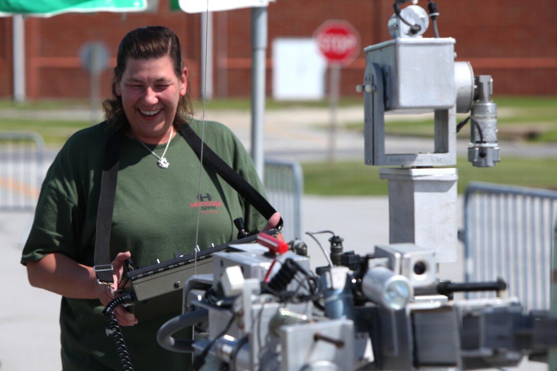 Lisa Miller operates a remotely-controlled explosive ordnance disposal vehicle during the Emergency Preparedness Fair in the station theater at Marine Corps Air Station Cherry Point, N.C., June 4, 2015. During the fair, service members and their families learned about resources available at Cherry Point and in surrounding communities to prepare for and respond to hurricanes and other natural disasters.