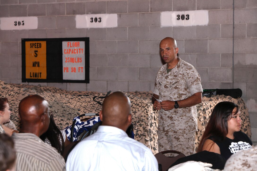 Lt. Col. Jaime Macias addresses a crowd of Marines and family members of Marine Wing Communications Squadron 28 during an “All Access Pass” event at Marine Corps Air Station Cherry Point, N.C., June 5, 2015. MWCS-28 hosted the event to give families an opportunity to see and learn about their Marines’ daily work life, build relationships with the command, meet other families and build camaraderie with the unit and its leadership. Macias is the commanding officer of MWCS-28.