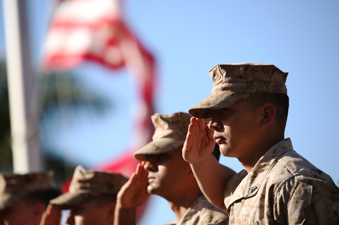 Cpl. Andres Garcia, a Marine with U. S. Marine Corps Forces, Pacific, salutes during Morning Colors before a conference room dedication ceremony at Camp H. M. Smith, Hawaii, June 9, 2015. The ceremony was held to dedicate three conference rooms to be named after Retired Sgt. Maj. Mike D. Mervosh, former Fleet Marine Forces Pacific sergeant major and veteran of World War II, Korea and Vietnam; Retired Lt. Gen. Henry Stackpole III, former MARFORPAC commander; and Jim Nabors, honorary Marine sergeant who played Gomer Pyle in a television show. (U.S. Marine Corps photo by Sgt. Sarah Anderson)