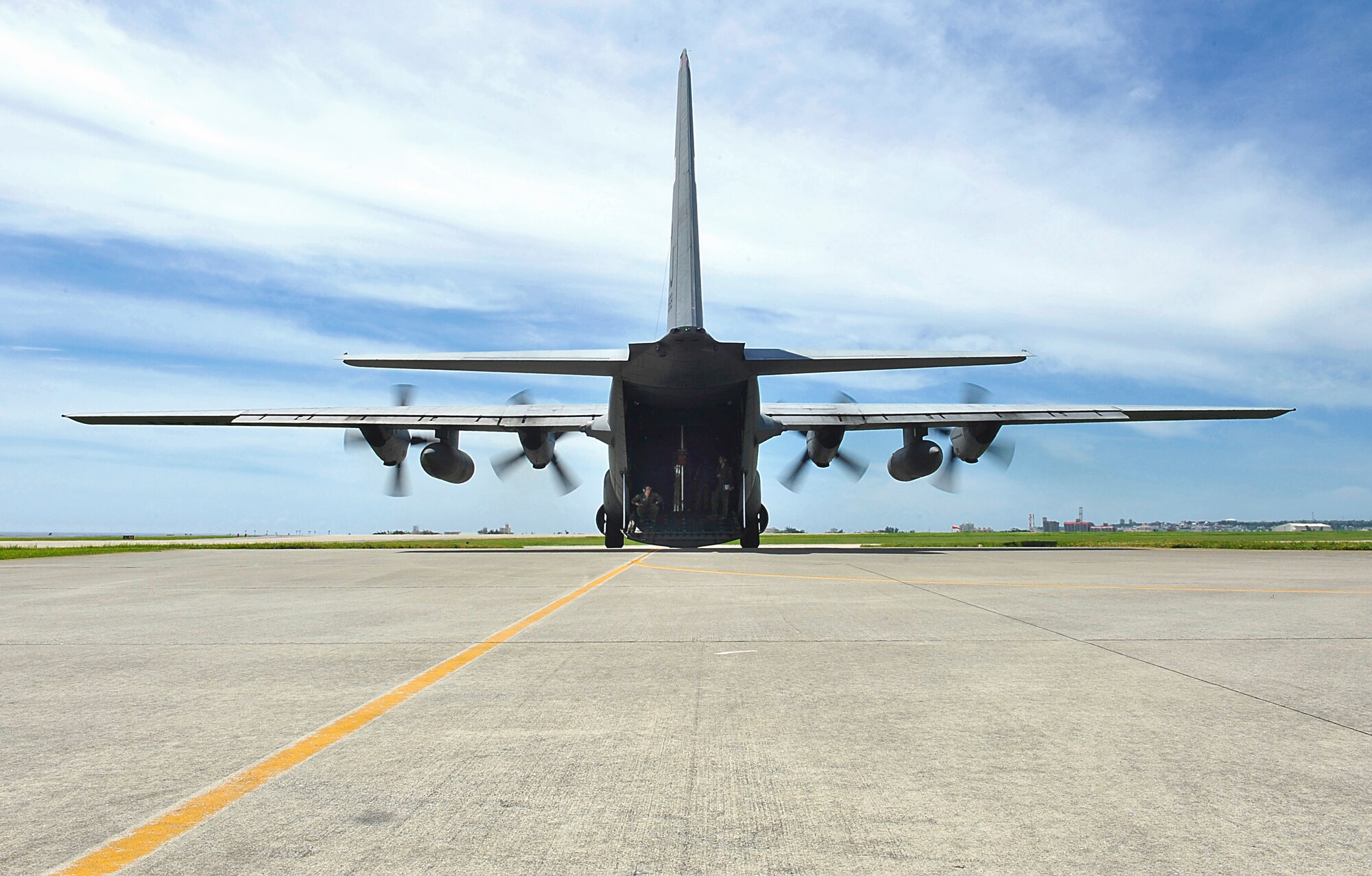 A U.S. Air Force C-130 Hercules aircraft from the 36th Airlift Squadron, Yokota, Japan, waits for pararescuemen from the 31st Rescue Squadron on Kadena Air Base, Japan, before flying to Ie Shima Island auxiliary airfield for jump training June 8, 2015. Day-to-day training ensures Airmen are prepared for real-world scenarios. (U.S. Air Force photo by Naoto Anazawa)