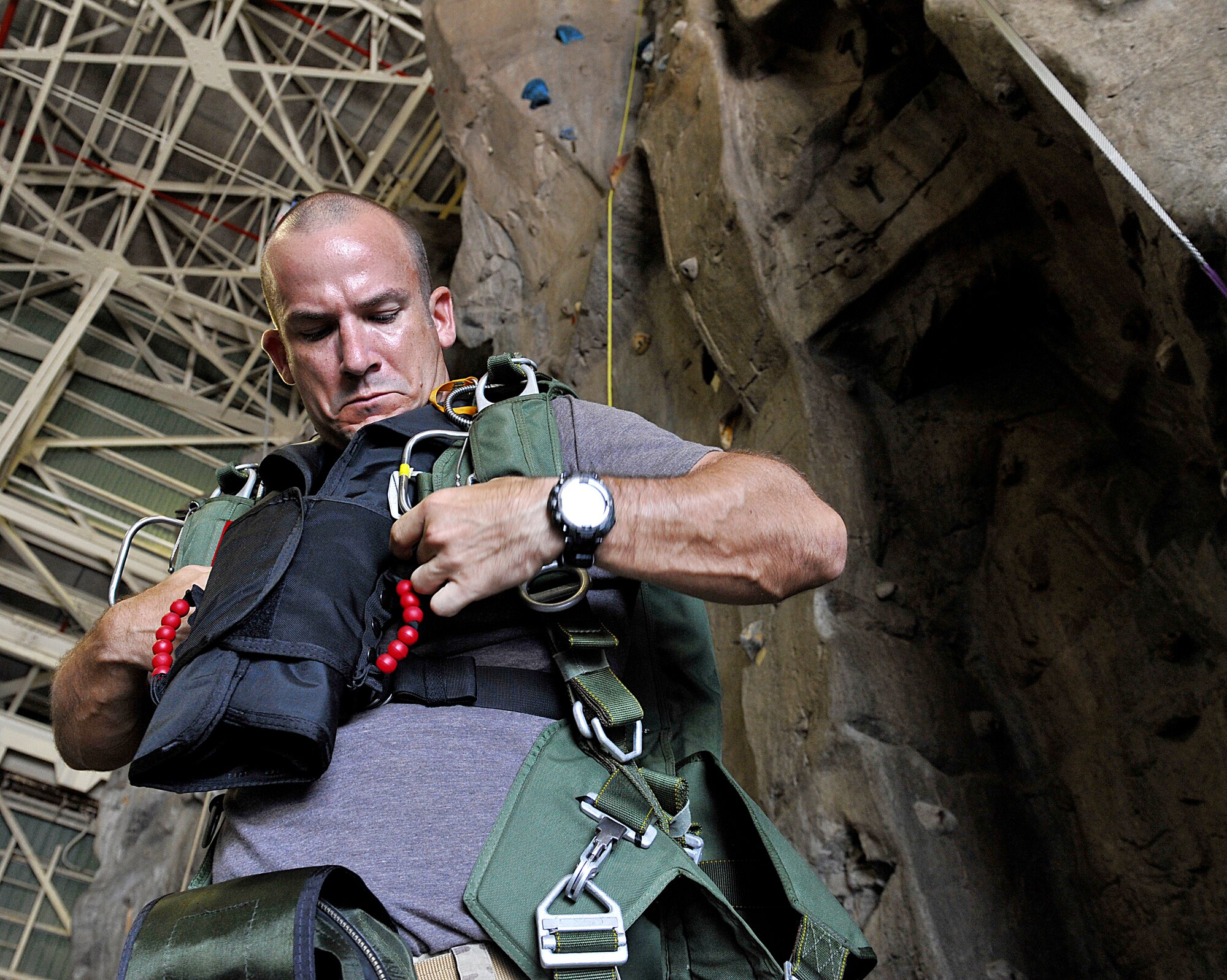U.S. Air Force Senior Master Sgt. Caleb Ethridge, 31st Rescue Squadron superintendent, dons parachute equipment on Kadena Air Base, Japan, before flying to Ie Shima Island auxiliary airfield for jump training June 8, 2015. The 31st RQS and 36th Airlift Squadron conduct jump training to provide the Kadena rescue squadron Airmen with a vital training environment that prepares them for real-world scenarios. (U.S. Air Force photo by Naoto Anazawa)