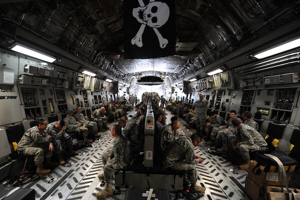 National Guardsmen aboard a C-17 Globemaster III from Joint Base Elmendorf-Richardson, Alaska, prepare for departure in preparation for Golden Coyote at Ellsworth Air Force Base, S.D., June 5, 2015. According to South Dakota National Guard Public Affairs, 35 military units representing 12 states will team up with military members from three foreign nations to create realistic training scenarios simulating contingency operations both at home station and abroad. (U.S. Air Force photo by Airman 1st Class James Miller/Released) 
